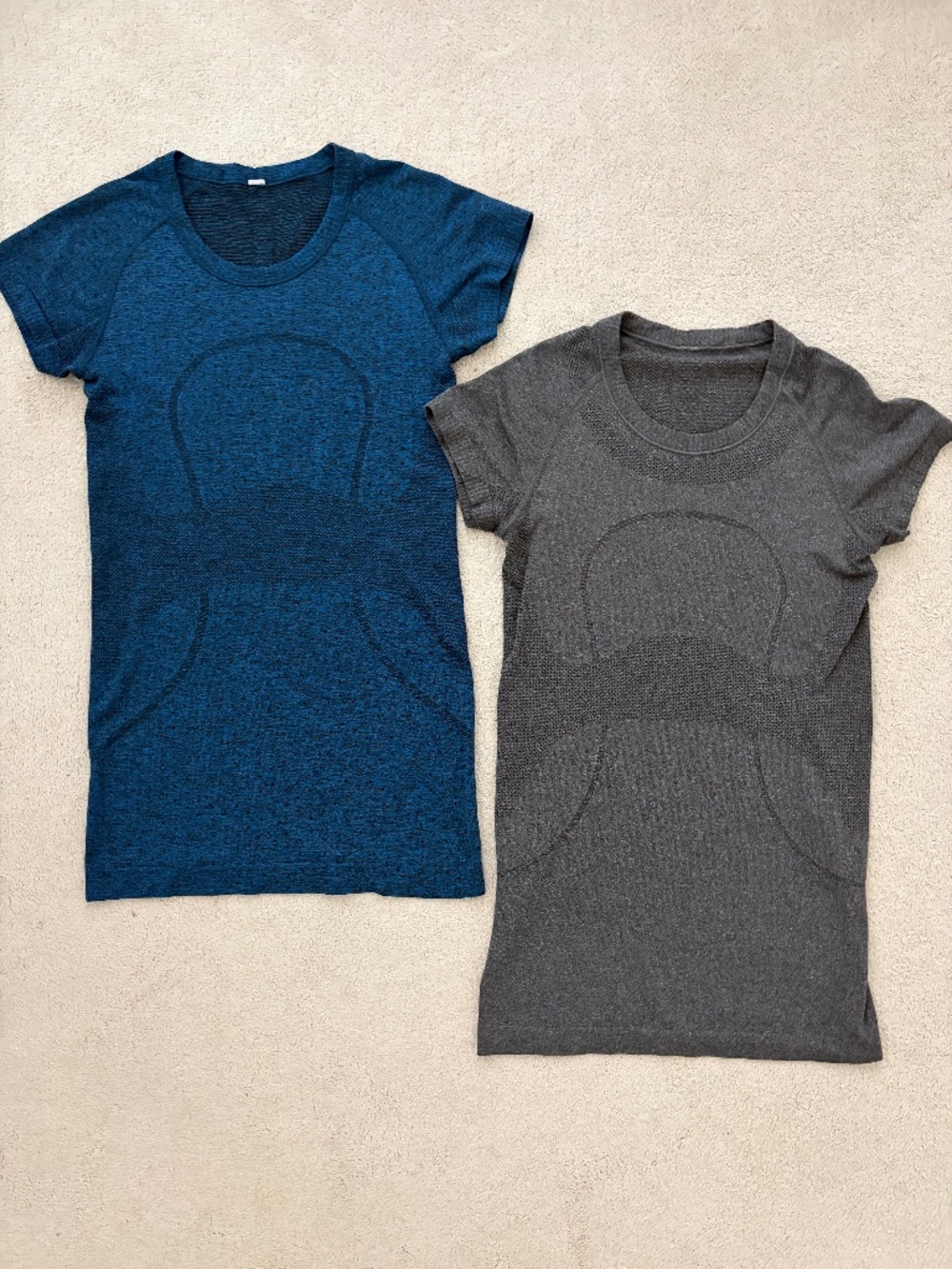 Two Lululemon size 4 swiftly tees navy and gray